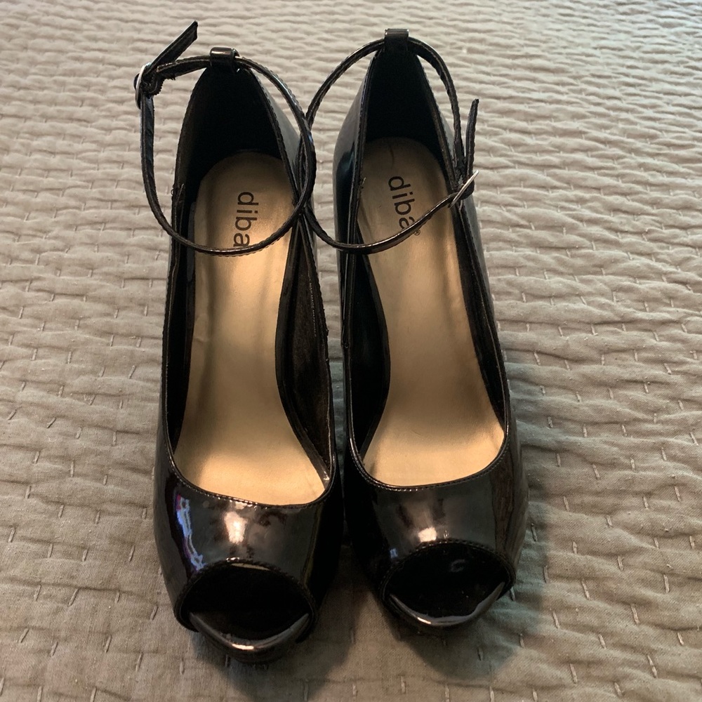Black patent leather platform stilettos.